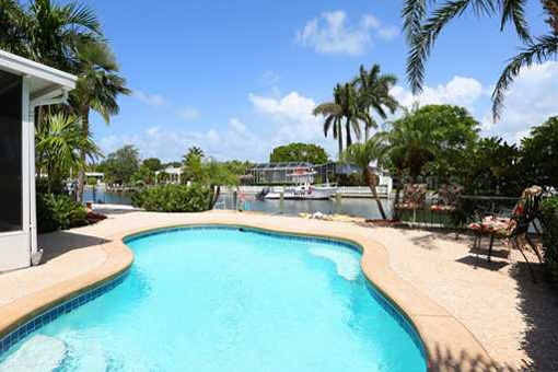 Backyard with heated pool and canal view