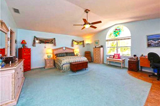 The spacious double bedroom with elevated ceiling