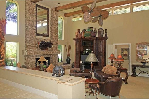 Living room with fireplace and ceiling fans in Fort Myers