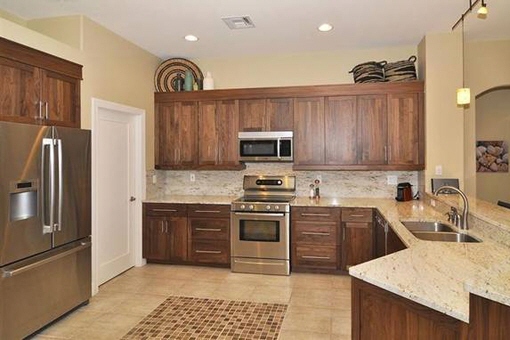 Gourmet kitchen with walnut cabinets in Fort Myers